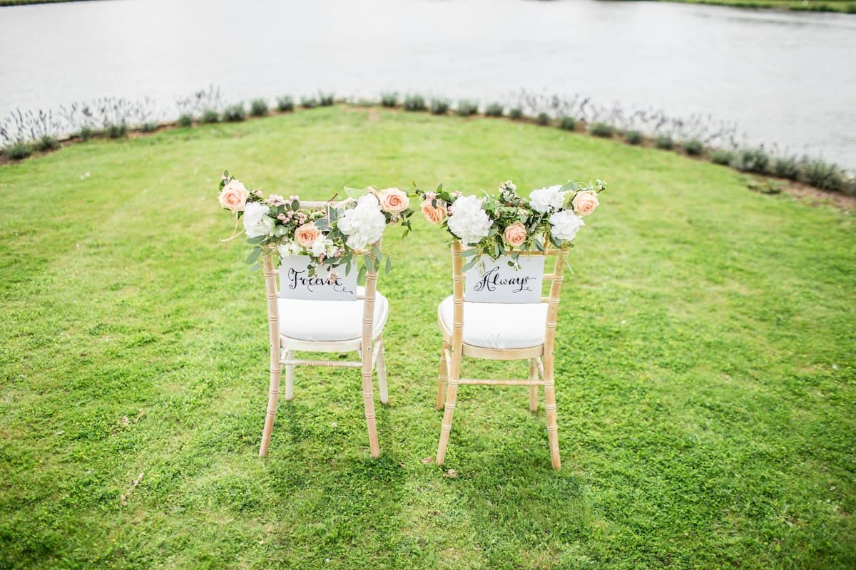 Two decorated chairs on a lawn
